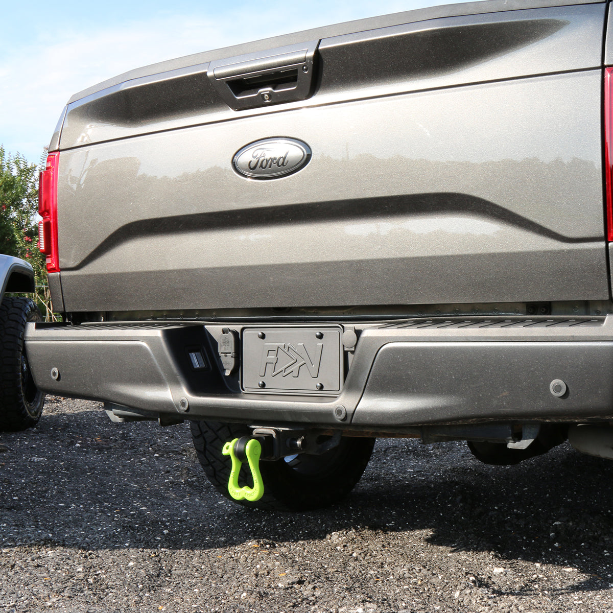 Moose Knuckle Offroad Tow Shackles on the bumper of a 2015 Ford F150 Magnetic Grey Lariat Sport Truck Nuts